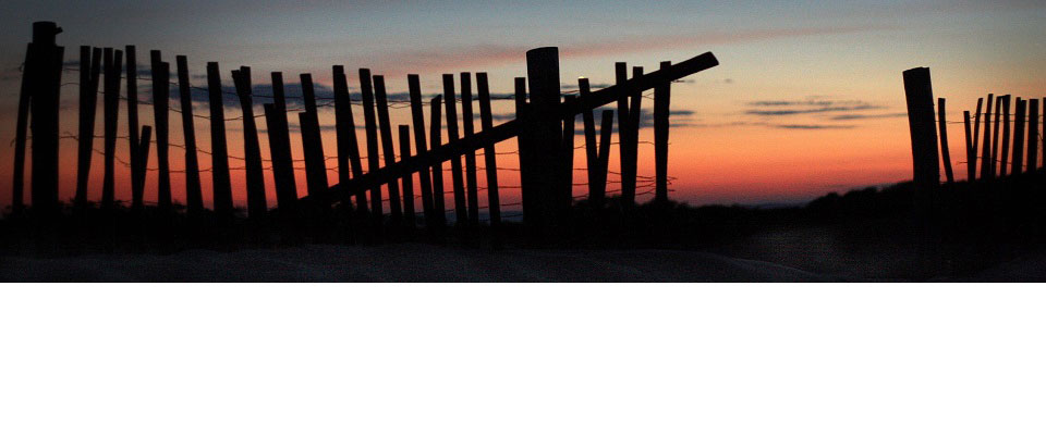 Beach fence at sunset
